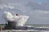 Wave hits a lighthouse