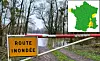 A French sign reading 'flooded road' and a map of France showing weather alerts