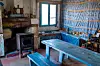 Room in La Maison d’Ambroise with a fire stove and wooden table with benches