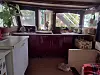 The small boat kitchen with a cat sitting on the floor