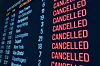 Departure board shows flight cancellations