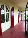 A terrace with red doors and bricks