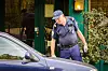 A police officer checks a car in France