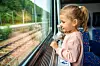 Little,Girl,With,Toy,Looking,Out,Train,Window,Outside,,While