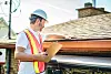 A,Man,With,Hard,Hat,Standing,On,Steps,Inspecting,House