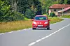 France,,1,July,2024:,Red,Car,Driving,On,A,Countryside