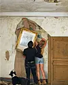 Couple hanging portrait in dilapidated building