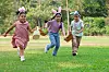 Kids wearing easter bunny ears running in a field