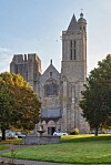 Saint-Samson Cathedral in Dol-de-Bretagne framed by trees and a foreground fountain