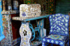 Mosaic-tiled sewing table and chair in a colourful patterned room