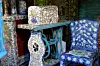 Mosaic-tiled sewing table and chair in a colourful patterned room