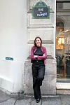 Woman standing under a 'Rue du Climat' sign on a Paris street