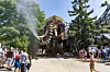 Crowds watch a giant mechanical elephant spraying water at the Machines of the Isle in Nantes.