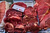 Assorted raw beef cuts on a tray with a label for bourguignon stew.