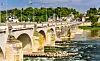 Stone arch bridge over the Loire River in Tours, France, with buildings and trees in the background.