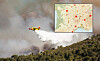 Firefighting aircraft releases water over a smoky hillside, with a small map inset in the top right.