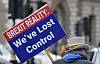 A person holds a sign reading 'Brexit reality: We’ve lost control' during a protest in London.