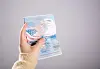 Close-up of a hand holding an American passport.