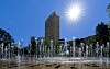 Fountain jets spray water in Courbevoie under bright sun during a heatwave near Paris.