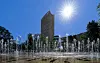 Fountain jets spray water in Courbevoie under bright sun during a heatwave near Paris.