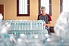 Man arranges bottled water at a distribution point in Montsalvy during France’s 2022 drought.
