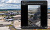 Airport runways and aircraft sit behind a vertical video showing a dense black smoke plume.