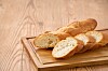 Sliced French baguette on a wooden cutting board