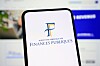 Smartphone displaying the French Finances Publiques logo in front of a blurred computer screen