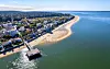 Aerial view of Arcachon’s sandy beach, waterfront pier, town and calm Atlantic bay