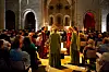 Choristers in colourful robes perform before an audience inside Sylvanes Abbey in Aveyron, France.