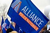 Blue Alliance Police Nationale flags held aloft at a Paris gathering