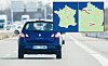 Blue hatchback driving on a motorway with an inset map of France and nearby roads.