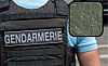 French gendarmerie vest beside a smartphone showing a map