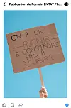 Hand holding a French placard calling for a future to build against a blue sky