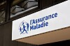 L’Assurance Maladie logo and sign displayed on a building in Paris, France.