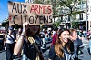 High-school students march in Paris as a protester holds an “Aux armes citoyens” placard.
