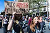 High-school students march in Paris as a protester holds an “Aux armes citoyens” placard.