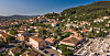 Panoramic view of Cuers, with terracotta-roofed buildings and wooded hills in the Var.