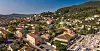 Panoramic view of Cuers, with terracotta-roofed buildings and wooded hills in the Var.